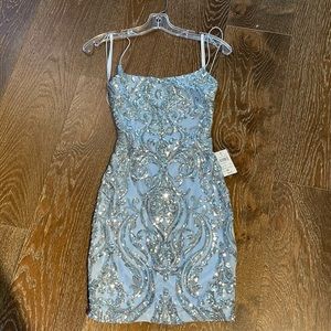 Never worn girls party dress. Light blue with silver sequins.